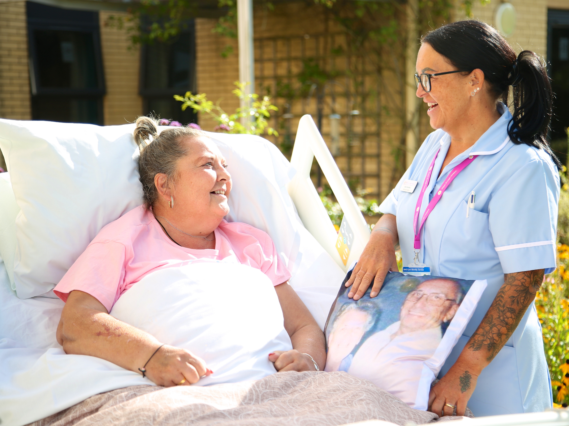 Hospice nurse sharing a warm moment with a patient at her bedside